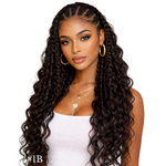 Woman with long, wavy hair styled in cornrows, wearing a white top on a white background.
